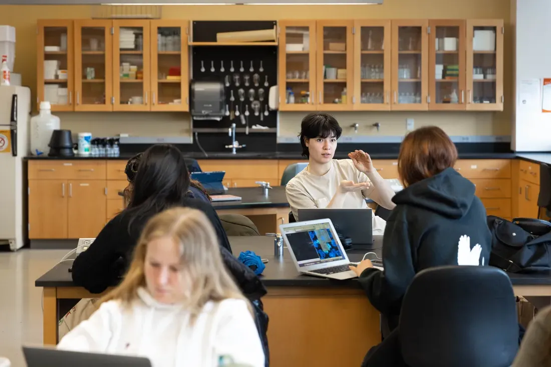 Students sit in biology classroom.